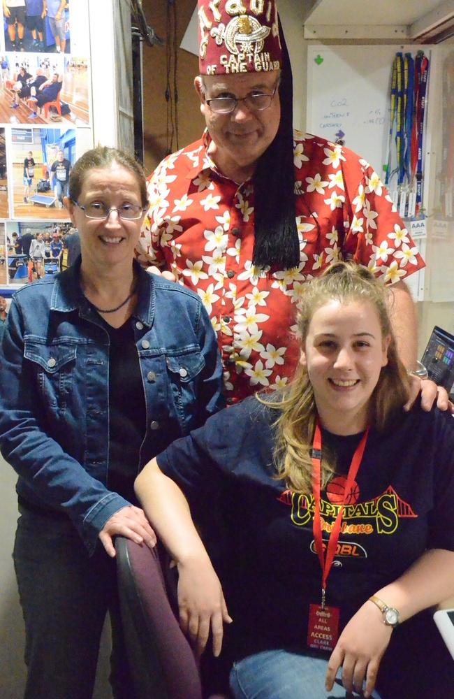 Fan Fair (middle) at work as the courtside announcer for the Brisbane Capitals.