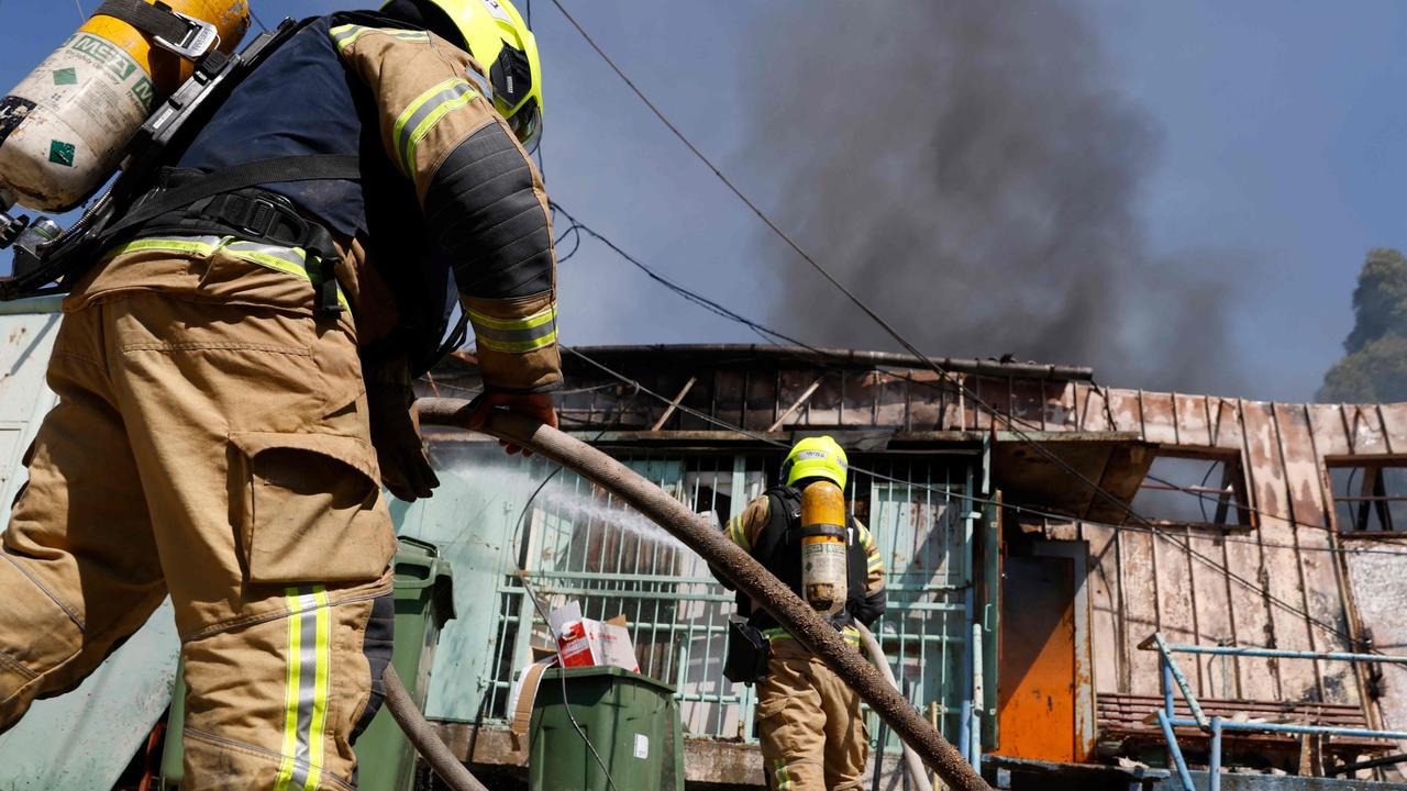 Israeli firefighters battle a blaze at the site of an rocket strike, fired from southern Lebanon, in Kiryat Shmona in northern Israel on September 24. Picture: Jalaa Marey/AFP