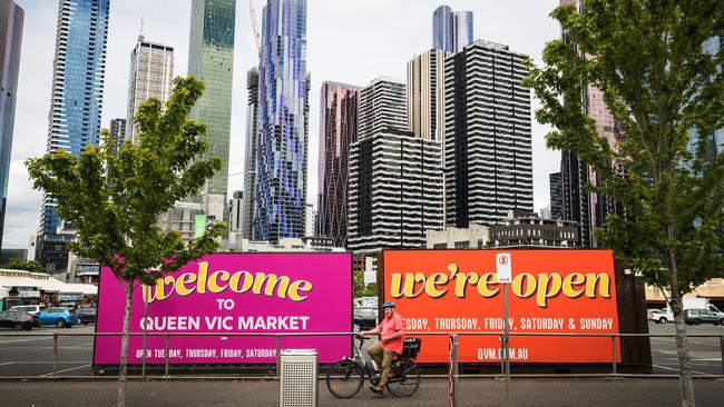 Welcome back signs are displayed outside the Queen Victoria Market