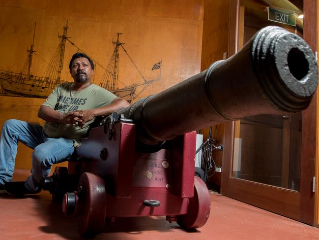 Harold Ludwick, Bulgun Warra man, at the James Cook Museum with one of the cannons thrown overboard after running aground on the Great Barrier Reef in 1770. Picture: Marc McCormack