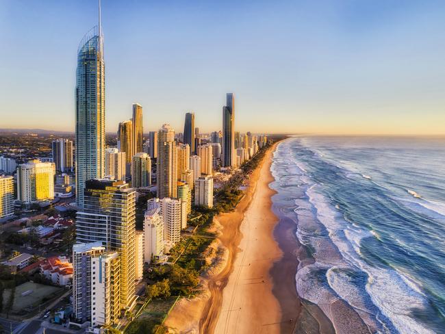 ESCAPE 9 JAN 2022. SAVVY. Waterfront behind sandy beach of SUrfers paradise greeting rising sun over Pacific ocean. Aerial view along Gold Coast and line of high-rise towers. Picture: iStock