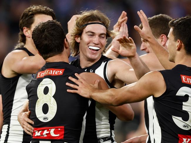 Harvey Harrison of the Magpies celebrates a goal with teammates. Picture: Michael Willson/AFL Photos via Getty Images.