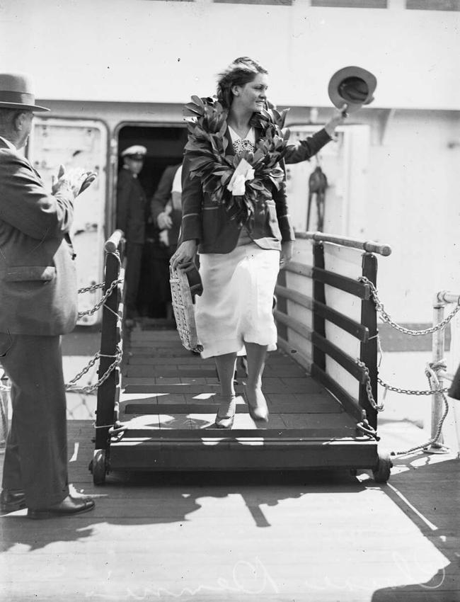 Swimmer Clare Dennis wearing the laurels of victory as she disembarks from the ship Mariposa at Circular Quay onSeptember 16, 1932. Picture: Fairfax Archive National Library of Australia