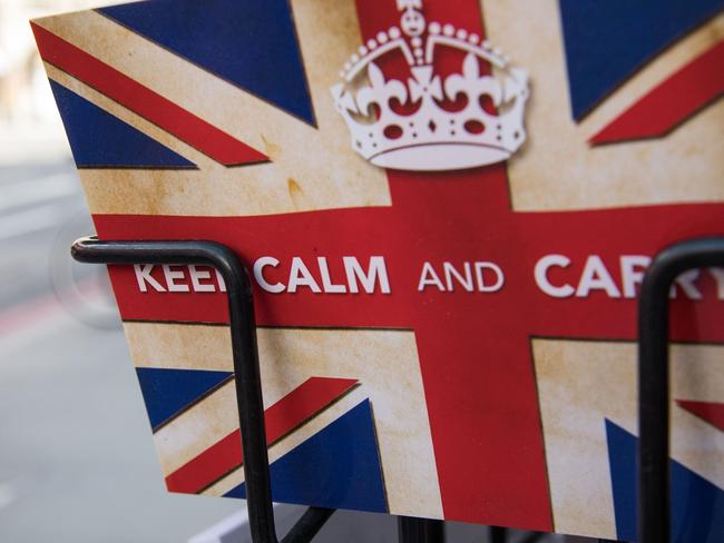 TOPSHOT - Postcards featuring the World War II British slogan "Keep Calm and Carry On" are seen outside a newsagents in London, on 24 June, 2016.  Britain voted to break away from the European Union on June 24, toppling Prime Minister David Cameron and dealing a thunderous blow to the 60-year-old bloc that sent world markets plunging. / AFP PHOTO / LEON NEAL