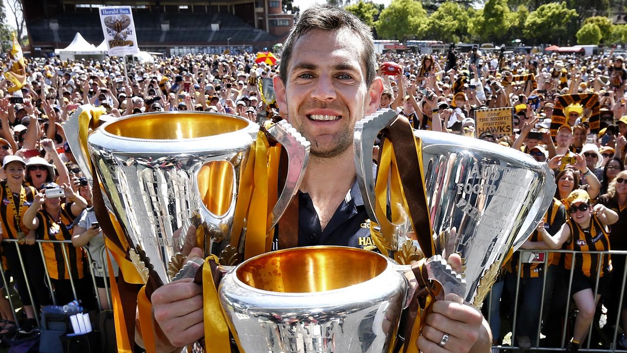 Luke Hodge shows off the club’s silverware to the Hawks faithful at Glenferrie Oval. Picture: Michael Klein