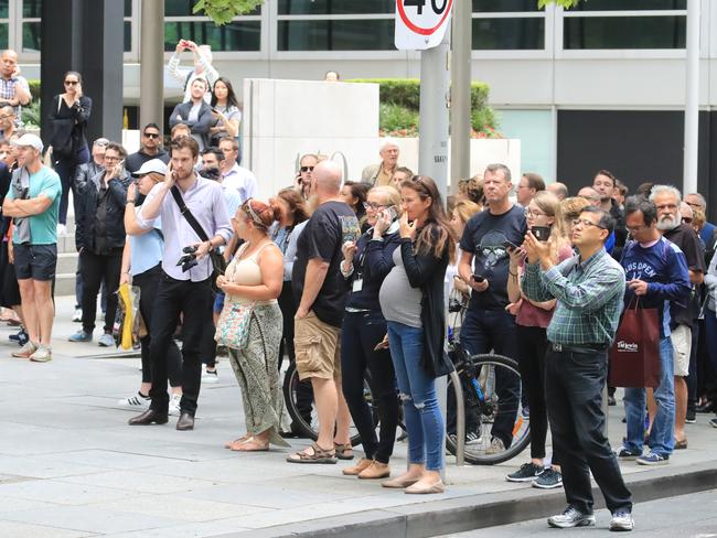 Stunned locals in Melbourne CBD try to work out exactly what just happened. Picture: Alex Coppel