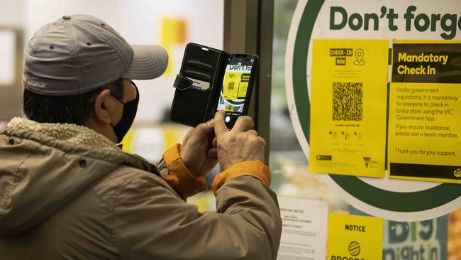 A person scans a QR code before entering a supermarket in Carlton, Melbourne. Picture: NCA NewsWire/Daniel Pockett