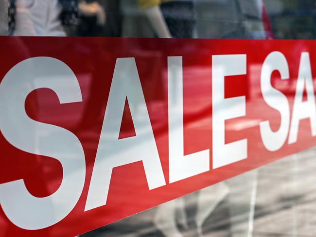 Picture of shop window display with text Sale on red poster