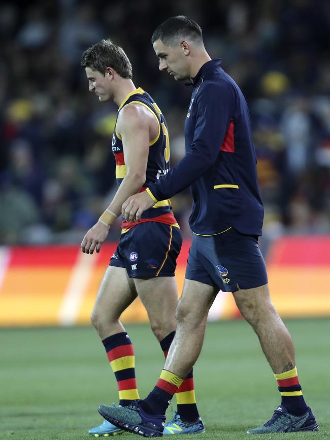 Taylor Walker in his tracksuit alongside Matt Crouch after injuring a hamstring on Saturday night. Picture Sarah Reed