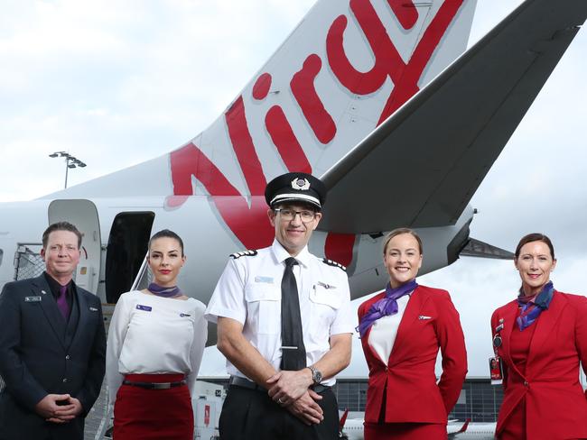 10/3/21: L to R..Nico Porter(CS), Bianca Yates, Captain Paul Anderson, Delia Taylor and Cindy Donaghy from guest services. Virgin Australia crew are set to benefit from a suite of assistance measures being rolled out by the federal government to help airlines and the tourism industry continue to recover. John Feder/The Australian.