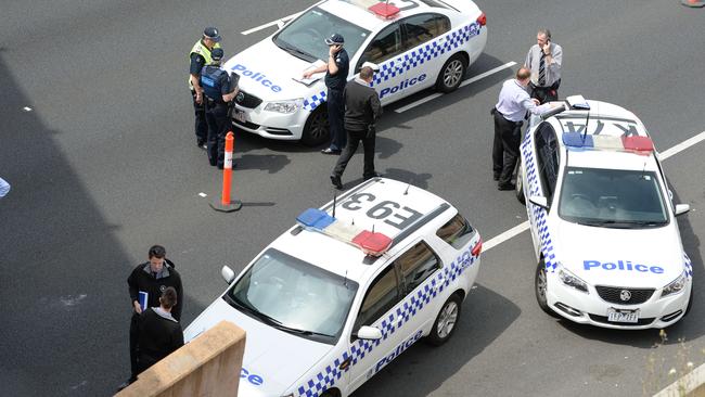 Police investigate the scene outside the Melba Tunnel on EastLink. Picture: Lawrence Pinder