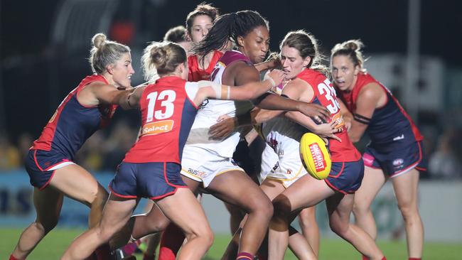 Brisbane’s Sabrina Frederick-Traub is surrounded by Dees players as she gets a kick away. Picture: AAP