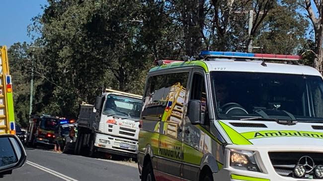 The scene of a truck and car crash on the Mary Valley Highway, where three people are being assessed by paramedics.