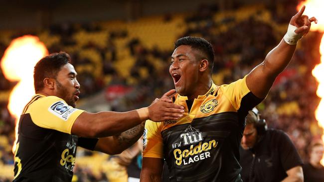 Julian Savea of the Hurricanes is congratulated on his try by teammate Vince Aso.