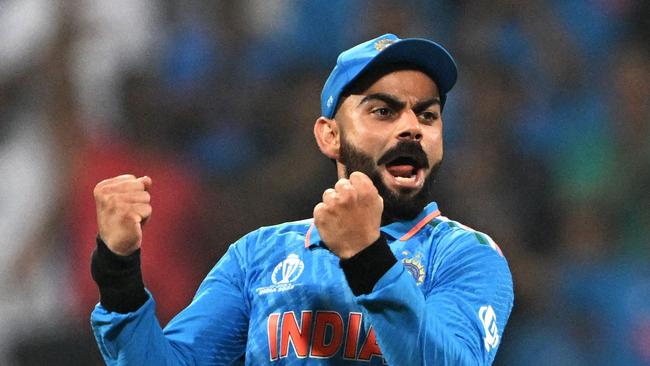 India's Virat Kohli celebrates after the dismissal of New Zealand's Daryl Mitchell during the 2023 ICC Men's Cricket World Cup one-day international (ODI) first semi-final match between India and New Zealand at the Wankhede Stadium in Mumbai on November 15, 2023. (Photo by Punit PARANJPE / AFP) / -- IMAGE RESTRICTED TO EDITORIAL USE - STRICTLY NO COMMERCIAL USE --