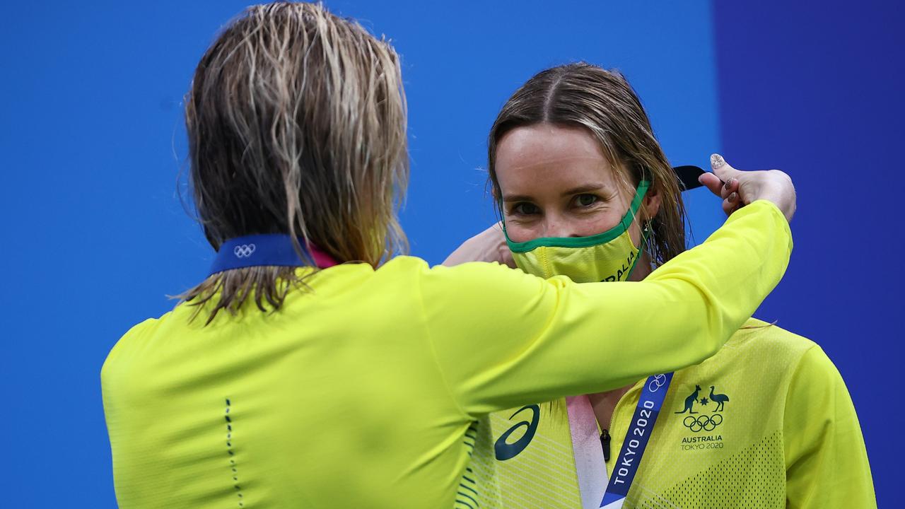 Emma McKeon receives her bronze medal from teammate Ariarne Titmus after the 4x200m relay.