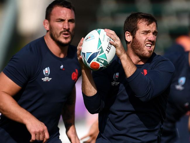 France's fly-half Camille Lopez (right) grabs the ball during a training session.