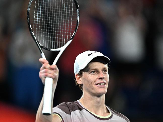 TOPSHOT - Italy's Jannik Sinner celebrates victory against Russia's Andrey Rublev during their men's singles quarter-final match on day 10 of the Australian Open tennis tournament in Melbourne on January 24, 2024. (Photo by Anthony WALLACE / AFP) / -- IMAGE RESTRICTED TO EDITORIAL USE - STRICTLY NO COMMERCIAL USE --