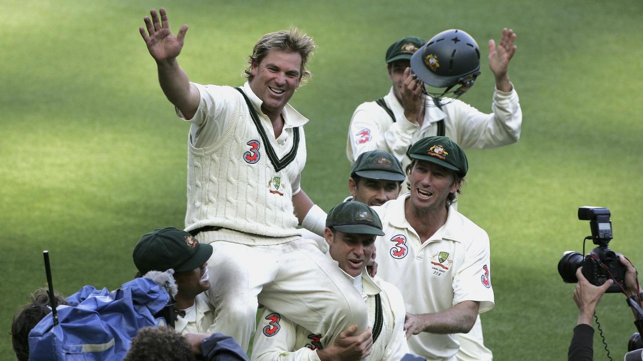 Shane Warne waves to the MCG crowd as he is chaired off by Andrew Symonds and Matthew Hayden after Australia won the fourth Ashes Test match in 2006.