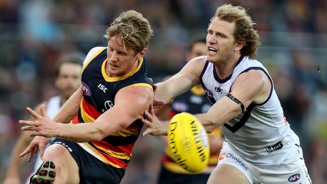 Rory Sloane of the Crows gets his kick away under pressure from David Mundy of the Dockers. Picture: Getty Images