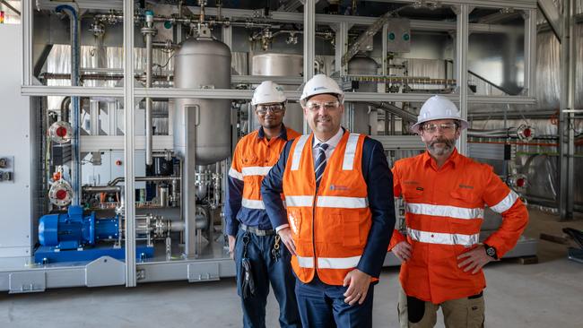 Siemens engineer Gabriel Samuel, Australian Gas Infrastructure Group general manager Craig de Laine and Siemens lead engineer Mark Walters with the electrolyser. Picture: Renewal SA