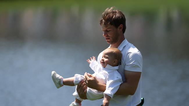 Thomas Detry on dad duty as he carries his daughter Alba Elizabeth. Picture: Getty