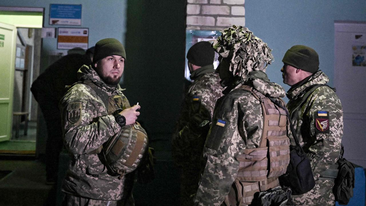 Ukrainian soldiers stand guard outside the building after the reported shelling of a kindergarten in Ukraine. Picture: AFP