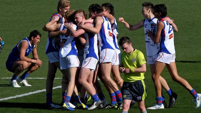 Oakleigh Chargers players are jubilant after winning the NAB League grand final last year.