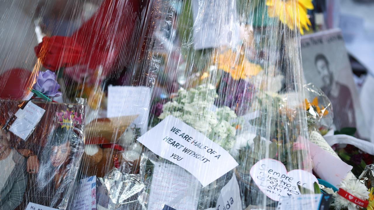 The memorial altar for singer Liam Payne is covered in plastic to protect it from the rain outside Casa Sur Hotel. Photo: Tobias Skarlovnik/Getty Images.