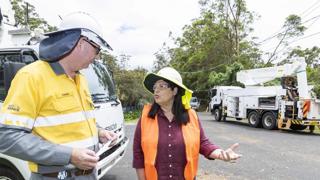 Chris Graham from Energex with Minister Grace Grace as crews continue storm clean-up at Kinabalu Drive, Tamborine Mountain. Picture: Richard Walker