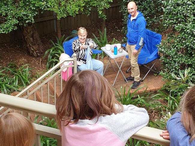 Gill Wade, 61, and husband Russell Wade, 62, sharing a tea party with grandkids Elliot, seven, Avery, five and Marlowe Hardwick, three.