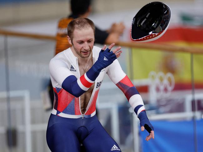 Britain's Jason Kenny tosses his helmet after taking gold in the track cycling keirin final. Picture: AFP