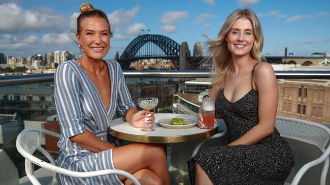 Nicci Crisp and Lauren Ferguson enjoy a cocktail at the Hotel Palisade, Millers Point ahead of the new hospitality rules. Picture: Justin Lloyd