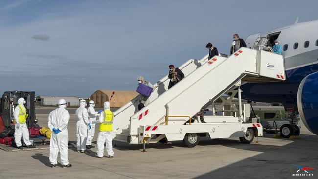 Medics wait for passengers flown out from Wuhan to disembark from an aircraft at the Istres-Le Tube Air Base in southern France. Picture: AFP