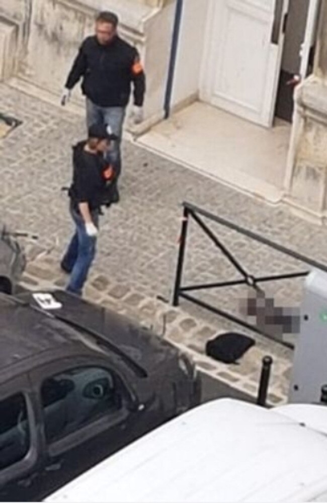 The Paris knifeman, Michael Harpon lies dead on the ground in the courtyard of police headquarters after killing four officers in a rampage today. Picture: Le Point