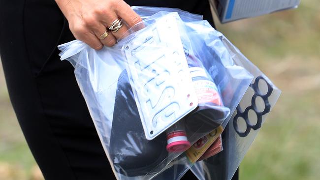 Police take items away from the scene at Kumnick Street, Upper Coomera where there was a shooting last night involving a Rebels bikie Gokhan Turkyilmaz. Pics Adam Head