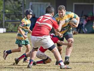 BIG RUN: Darling Downs under-12 player Oliver Dunk takes on the Brisbane Red line during the Queensland Rugby Union Junior State Championships. Picture: Nev Madsen