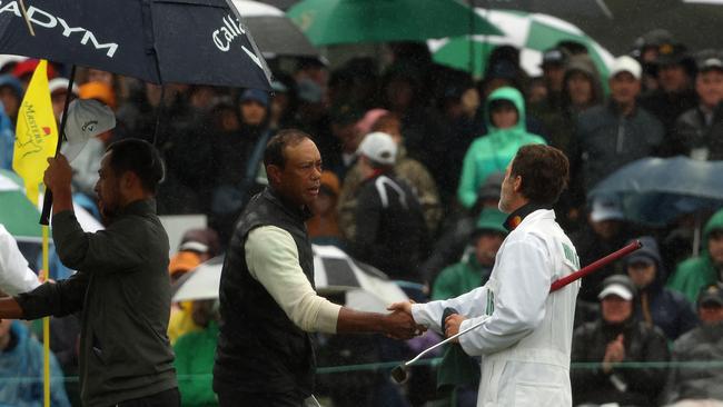 Tiger Woods shakes hands with Viktor Hovland’s caddie Shay Knight on the 18th green . Picture: Getty