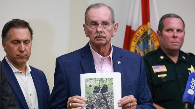 Palm Beach County Sheriff Ric Bradshaw holds a photograph of a rifle and other items found after an apparent assassination attempt at Trump’s Florida golf course, on September 15, 2024. Picture: AFP