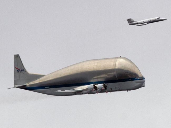 NASA's Super Guppy aircraft, carrying crew compartment for the Space Shuttle Trainer above Seattle in 2012. The Australian Airline Pilots’ Association warns of risk to aviation safety because of rockets going up but also debris coming down through commercial aircraft routes.