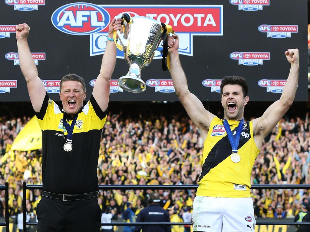 MELBOURNE, VICTORIA - SEPTEMBER 30:  Tigers head coach Damien Hardwick and Trent Cotchin of the Tigers lift up the Premiership Cup after winning during the 2017 AFL Grand Final match between the Adelaide Crows and the Richmond Tigers at Melbourne Cricket Ground on September 30, 2017 in Melbourne, Australia.  (Photo by Michael Dodge/AFL Media/Getty Images)