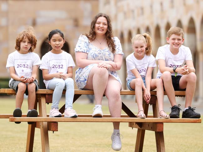 UQ Scholarship recipient Share Liddell who is studying public health with future University students Atticus Yezdani 8, Sophie Song 9, Chelsea Dawson 9, and Caleb Dawson 10, at University of Queensland Campus at St Lucia. Picture Lachie Millard