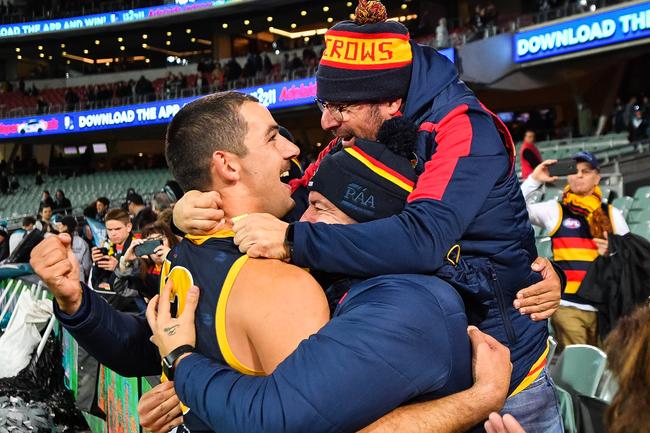 Crows co-captain Taylor Walker celebrates with fans after beating Port Adelaide in Showdown 46 at Adelaide Oval. Picture: Daniel Kalisz/Getty 