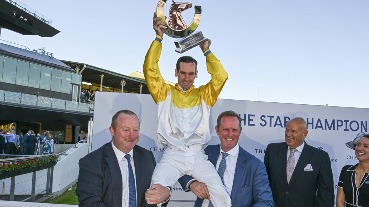 Co-trainers Wayne Hawkes (left) and Michael Hawkes lift jockey Tyler Schiller after Briasa won the TJ Smith Stakes at Randwick in April. Picture: Bradley Photos
