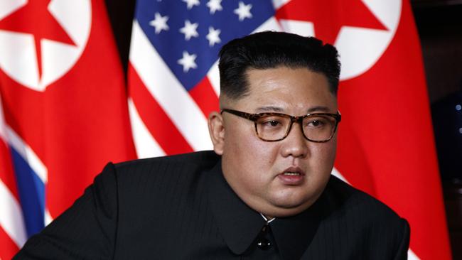 North Korean leader Kim Jong Un listens to U.S. President Donald Trump during a meeting on Sentosa Island in Singapore Tuesday, June 12, 2018. Kim showed up in an old communist uniform without a lapel pin with the images of his late father and grandfather who ruled successively before his inauguration in late 2011. (AP Photo/Evan Vucci)