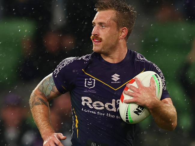 MELBOURNE, AUSTRALIA - APRIL 06:  Cameron Munster of the Storm makes a break to score a try during the round six NRL match between the Melbourne Storm and Sydney Roosters at AAMI Park on April 06, 2023 in Melbourne, Australia. (Photo by Graham Denholm/Getty Images)