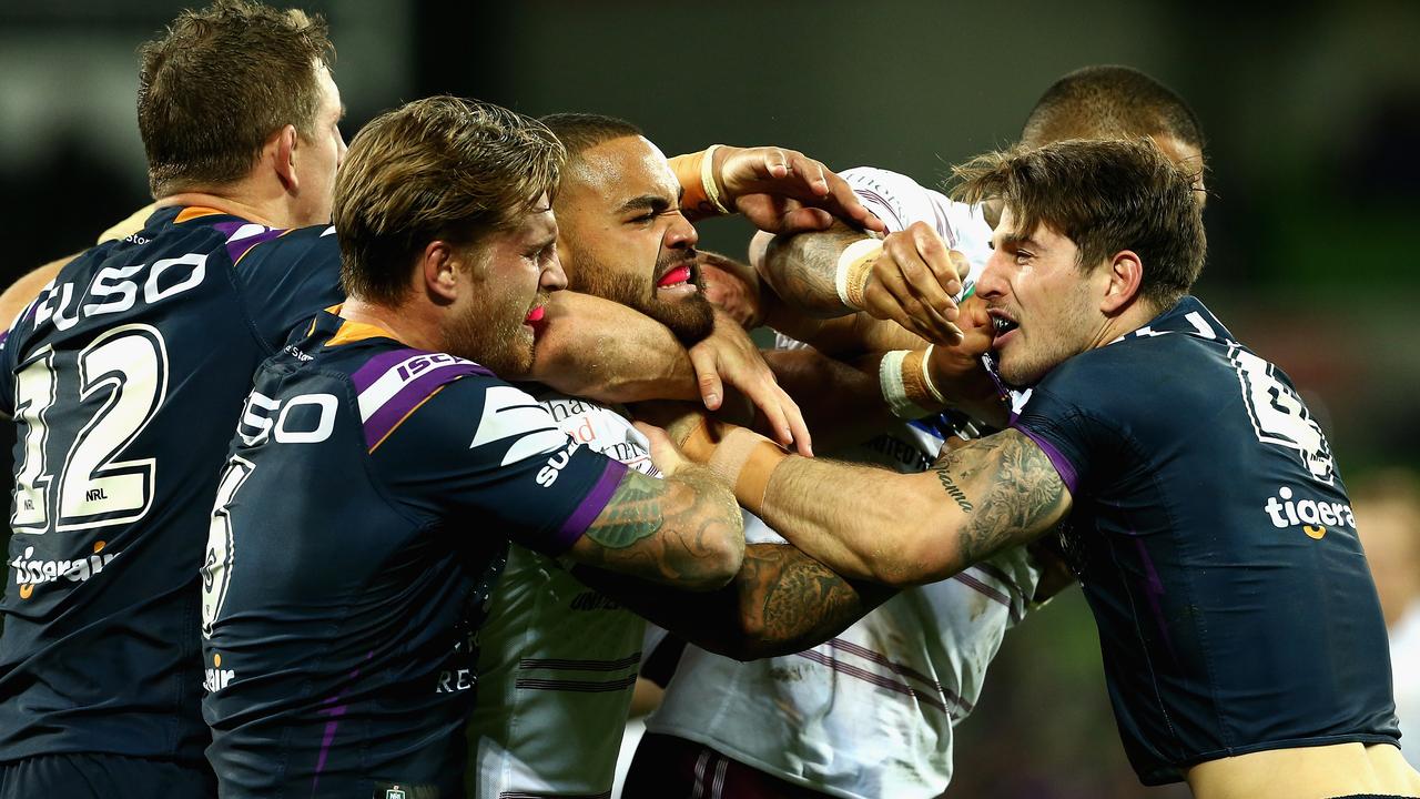 MELBOURNE, AUSTRALIA — MAY 19: Players wrestle during the round 11 NRL match between the Melbourne Storm and the Manly Sea Eagles at AAMI Park on May 19, 2018 in Melbourne, Australia. (Photo by Robert Prezioso/Getty Images)