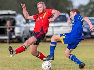 CLOSE CONTEST: USQ FC's Jedd Sugden attempts to evade Kurt Neuendorft's tackle. USQ won the Toowoomba Football League premier men's match 2-1. Picture: paul smith