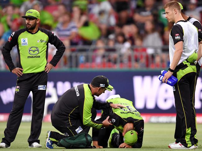 Chris Green receives medical attention after rolling his ankle during the BBL T20 match between the Sydney Thunder and the Adelaide Strikers at Spotless Stadium on Wednesday. Picture: AAP