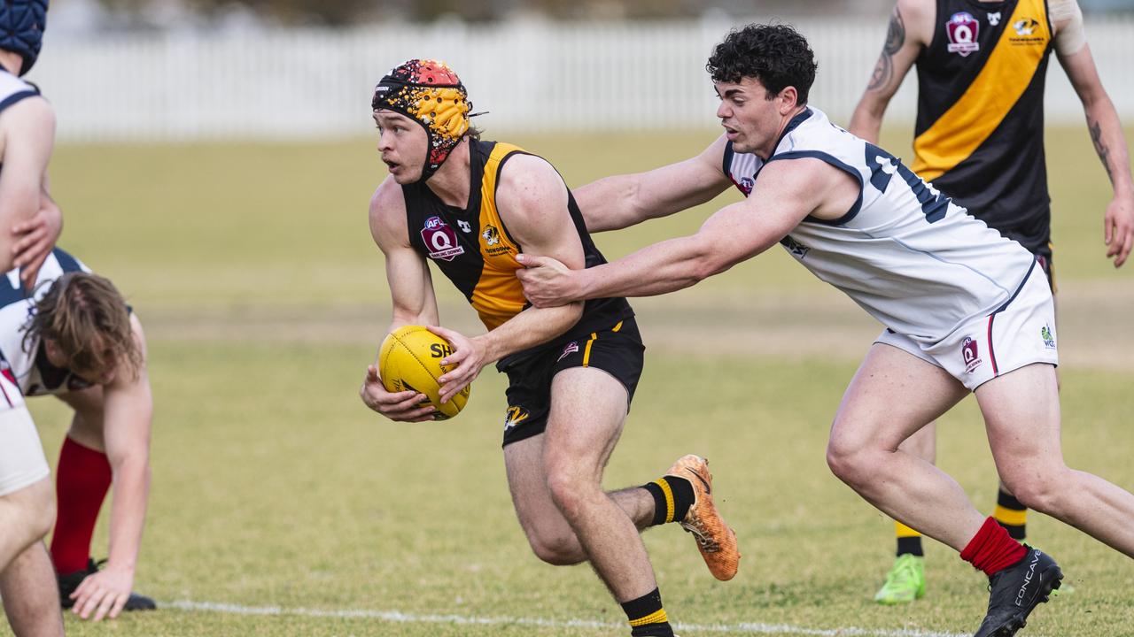 Joshua Challis of Toowoomba Tigers is tackled by Zac Wall. Picture: Kevin Farmer